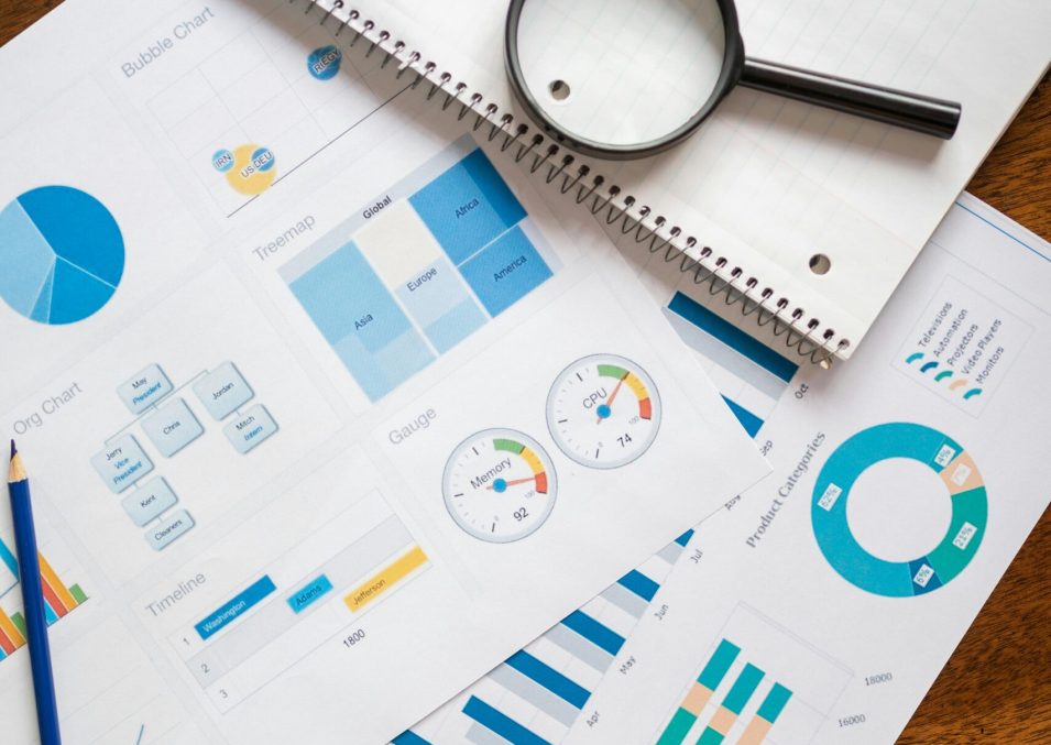 pexels-photo-7948058-7948058 A set of financial charts and graphs with a magnifying glass, perfect for business reports.